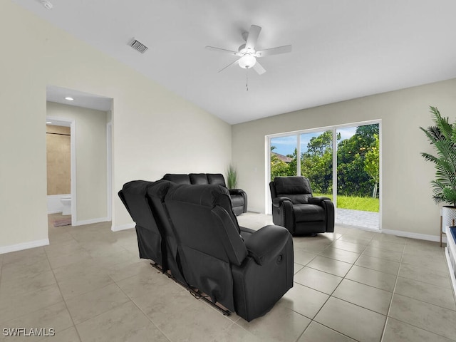 tiled living room with ceiling fan and lofted ceiling