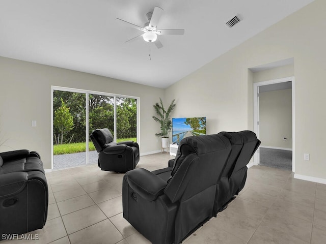 living room with ceiling fan, light tile patterned floors, and vaulted ceiling