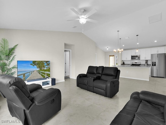 living room featuring lofted ceiling, ceiling fan with notable chandelier, and light tile patterned floors