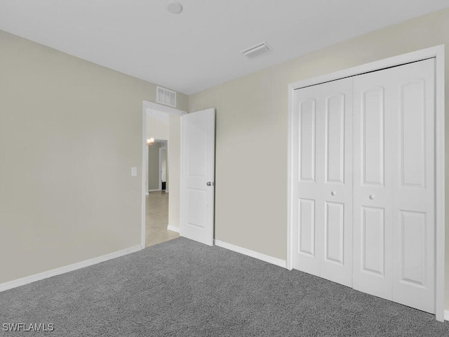 unfurnished bedroom featuring a closet and carpet floors