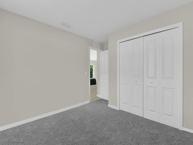 unfurnished bedroom featuring a closet and carpet floors