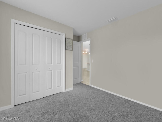 unfurnished bedroom with carpet floors and a closet