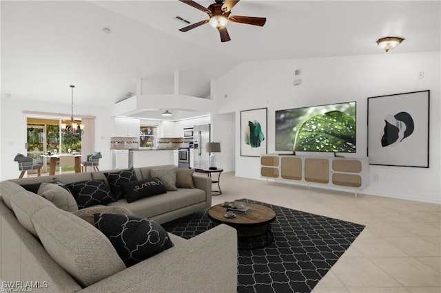 tiled living room with high vaulted ceiling and ceiling fan with notable chandelier