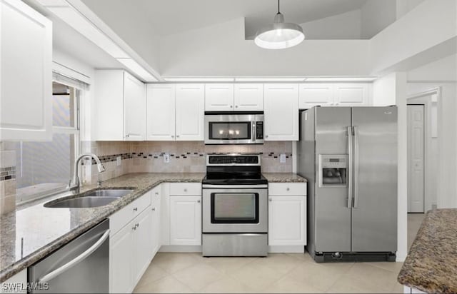 kitchen featuring sink, stainless steel appliances, decorative backsplash, and stone counters