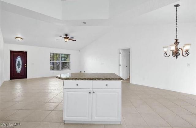 kitchen with ceiling fan with notable chandelier, hanging light fixtures, light tile patterned flooring, and white cabinetry