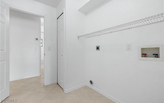 washroom with washer hookup, light tile patterned floors, and hookup for an electric dryer