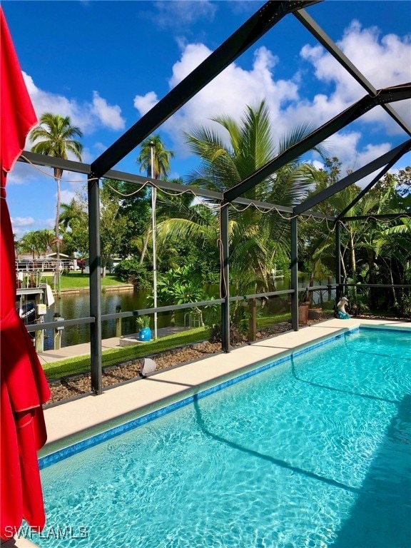 view of pool featuring glass enclosure