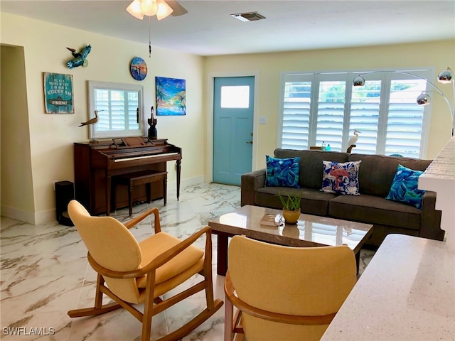 tiled living room featuring ceiling fan