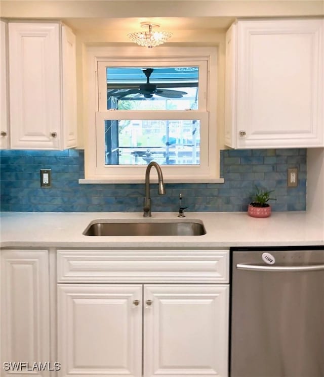 kitchen with sink, decorative backsplash, stainless steel dishwasher, and white cabinetry