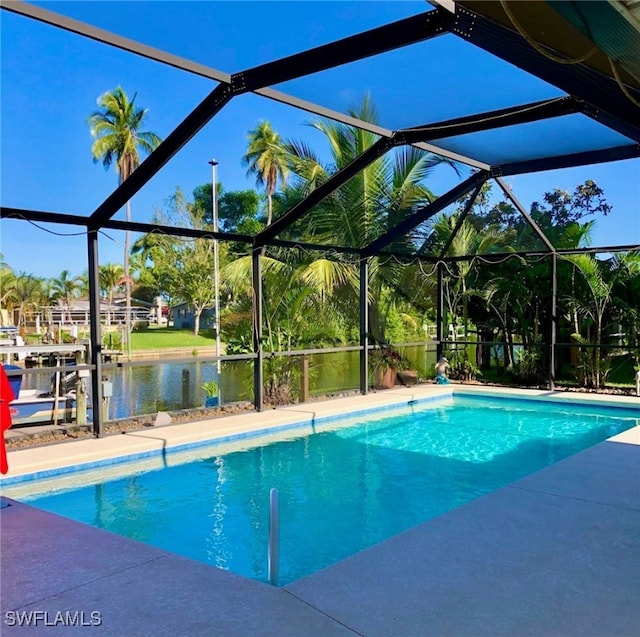 view of swimming pool with glass enclosure