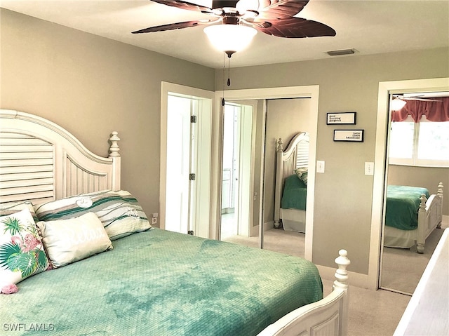 bedroom featuring a closet, ceiling fan, and light carpet