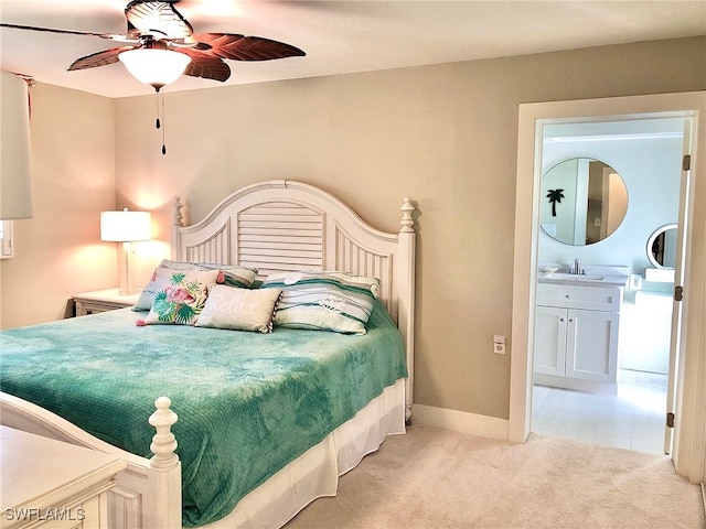 bedroom with sink, ceiling fan, connected bathroom, and light carpet