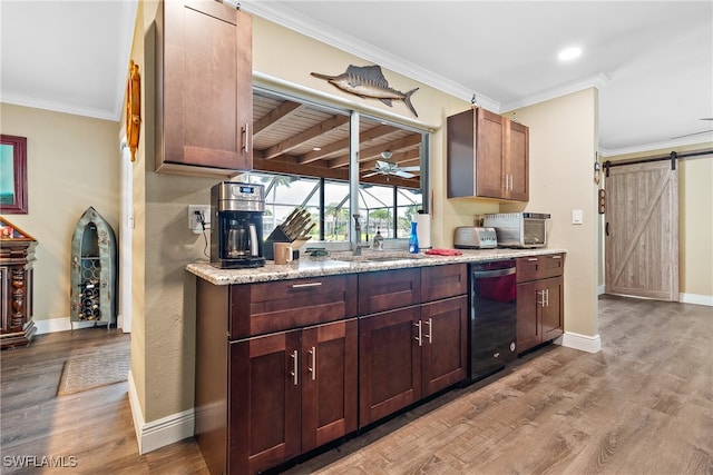 kitchen featuring light hardwood / wood-style flooring, dishwasher, crown molding, a barn door, and ceiling fan