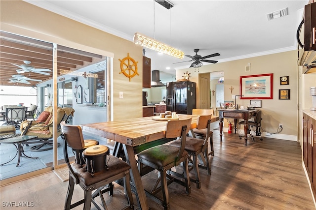 dining area with ceiling fan, ornamental molding, and wood-type flooring