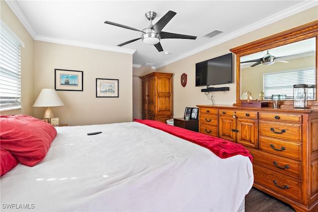 bedroom featuring crown molding, ceiling fan, multiple windows, and dark wood-type flooring