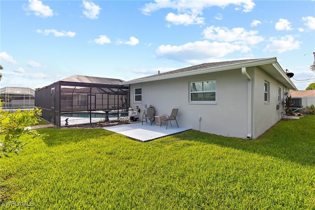 rear view of house with a lawn, a lanai, a patio area, and central AC unit