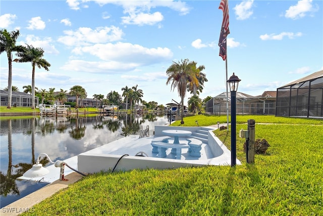 view of property's community with a water view and a yard