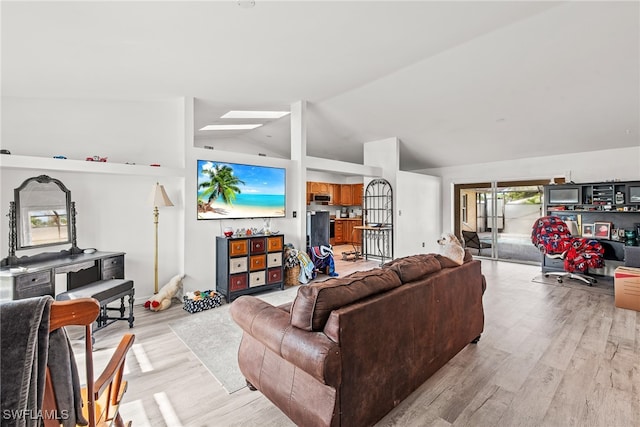 living room with lofted ceiling and light hardwood / wood-style flooring