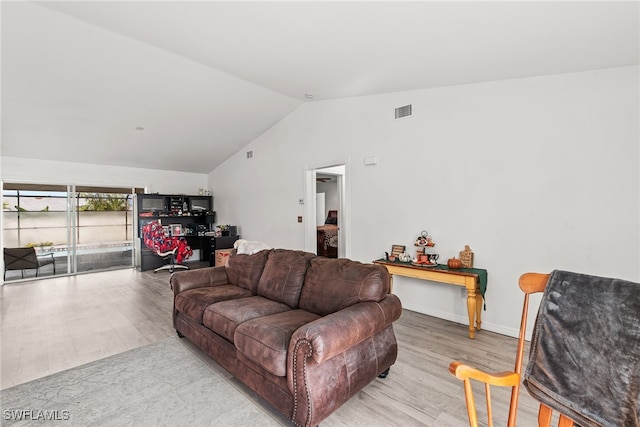 living room with vaulted ceiling and light hardwood / wood-style flooring