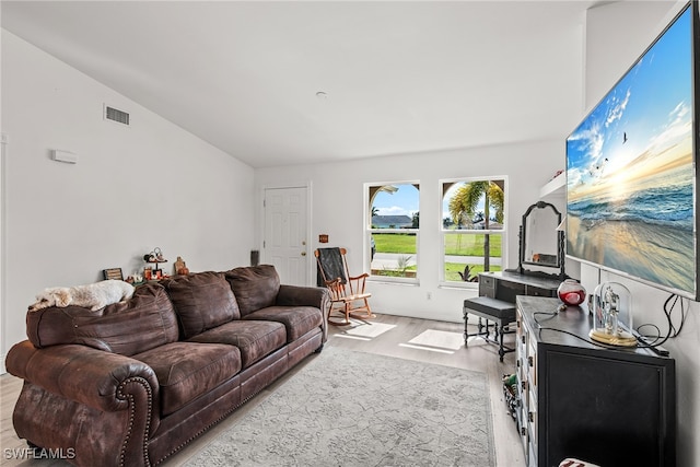 living room featuring light hardwood / wood-style floors and lofted ceiling