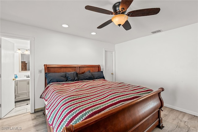 bedroom with ensuite bath, ceiling fan, and light hardwood / wood-style flooring