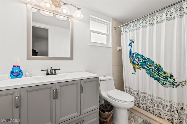 bathroom with vanity, curtained shower, and toilet