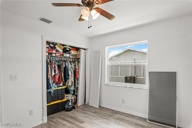 bedroom featuring ceiling fan, a closet, and light hardwood / wood-style flooring