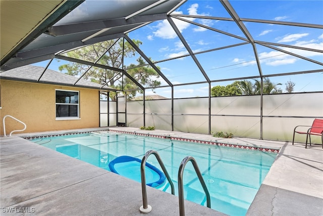 view of pool with a patio area and a lanai