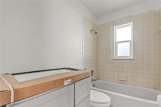 full bathroom with vanity, toilet, and tiled shower / bath