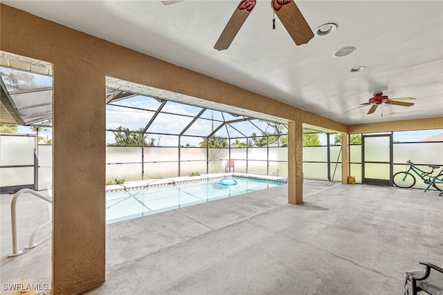 view of swimming pool with ceiling fan, a patio area, and a lanai