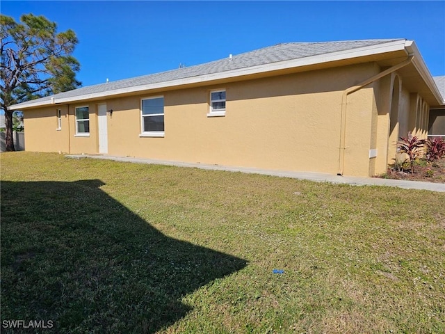 view of property exterior featuring a lawn