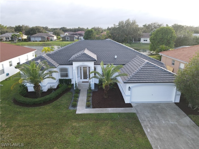 view of front of house with a garage and a front lawn