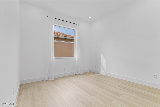 spare room featuring light wood-type flooring