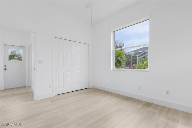 unfurnished bedroom with a closet and light hardwood / wood-style flooring