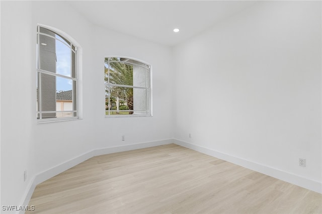 empty room with light hardwood / wood-style flooring