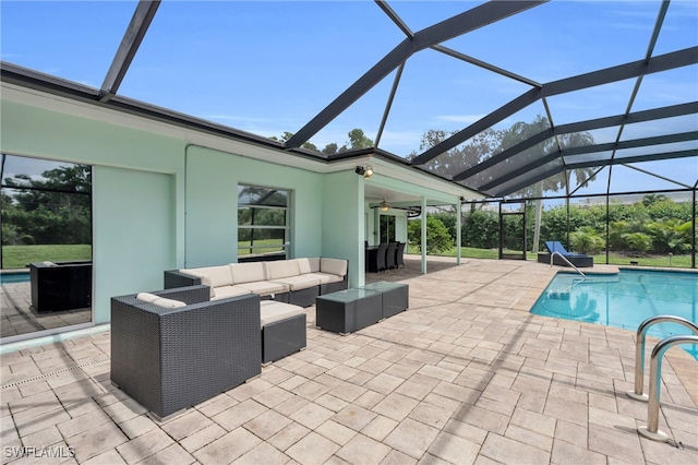 view of pool featuring an outdoor hangout area, glass enclosure, ceiling fan, and a patio