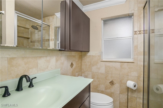 bathroom featuring walk in shower, toilet, crown molding, tile walls, and vanity