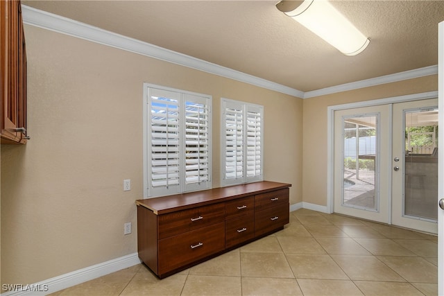 doorway with crown molding, light tile patterned floors, a textured ceiling, and french doors