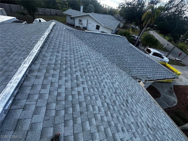 exterior details with roof with shingles