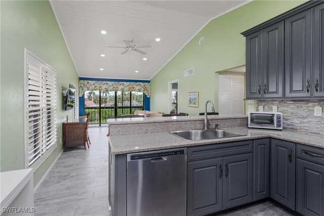 kitchen featuring light wood-type flooring, dishwasher, sink, ceiling fan, and lofted ceiling