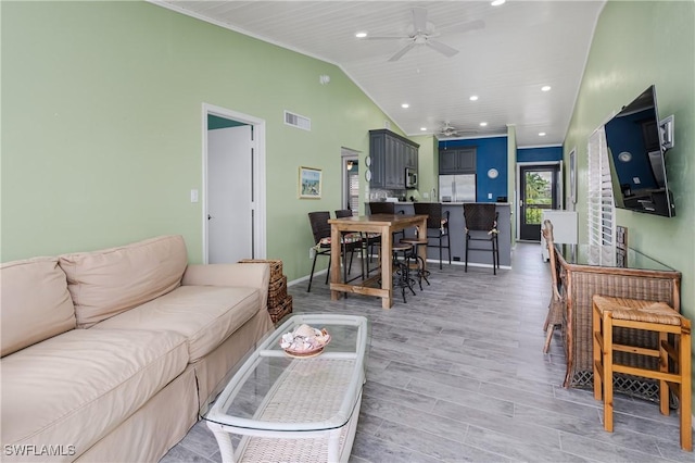 living room with visible vents, lofted ceiling, ceiling fan, light wood-style floors, and recessed lighting