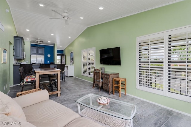 living room with baseboards, a ceiling fan, lofted ceiling, light wood-type flooring, and recessed lighting