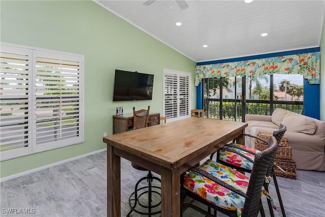 dining area with lofted ceiling, ceiling fan, recessed lighting, wood finished floors, and baseboards