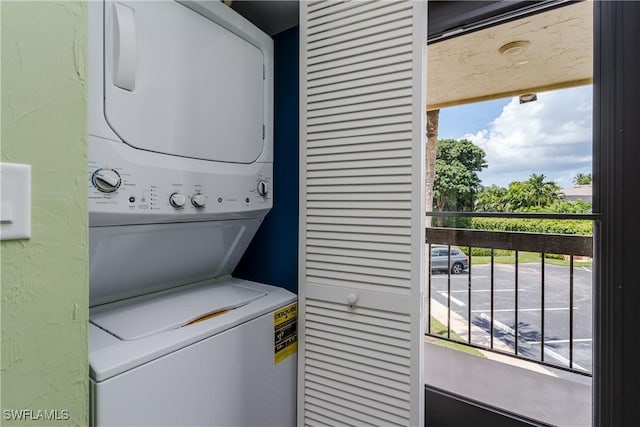 clothes washing area with laundry area and stacked washer / dryer