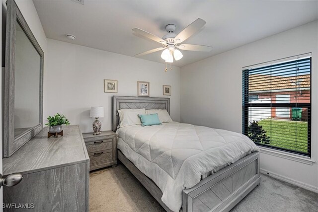 bedroom with light carpet and ceiling fan