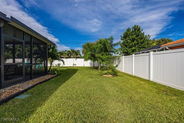 view of yard featuring a sunroom