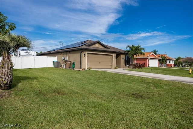 706 SW 9th Ct, Cape Coral, FL 33991 - ranch-style home with concrete driveway, an attached garage, roof mounted solar panels, and stucco siding