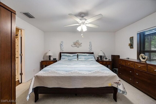 706 SW 9th Ct, Cape Coral, FL 33991 - bedroom with light colored carpet and a ceiling fan