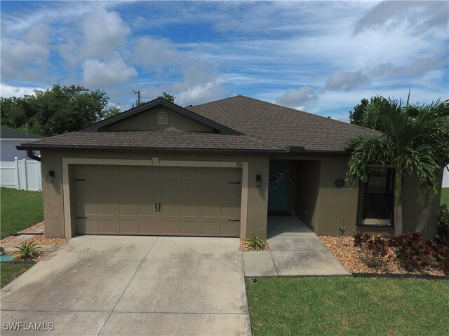 single story home featuring a garage and a front lawn