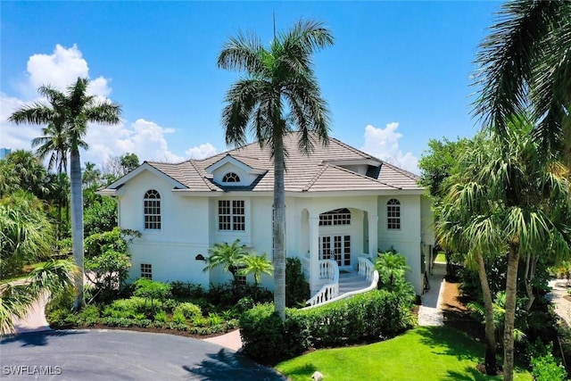 view of front of home featuring a front lawn and french doors